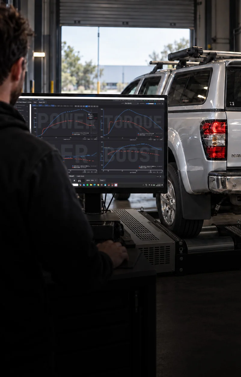 A 4WD strapped down on the Legendex dyno mid run, the operator watching the trace