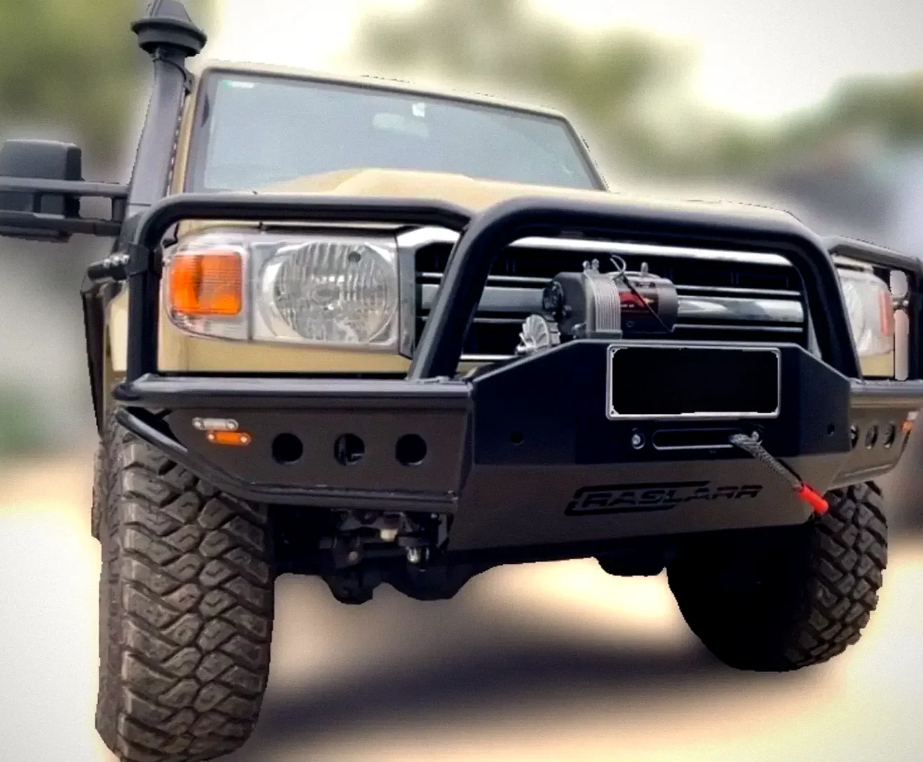 A sand-coloured 70 Series LandCruiser with a Raslarr bull bar, a winch and a snorkel
